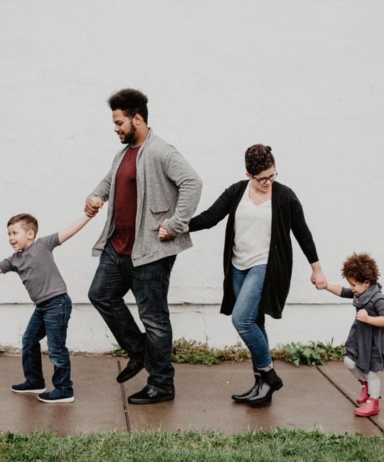 Family of four people, including a father, a mother, and two children.
